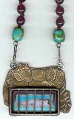 Inside-Outside, a fabricated pendant with cloisonné enamel and an engraved gold bi-metal tiger