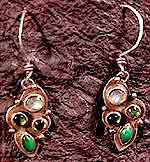 small silver earrings set with green gemstones