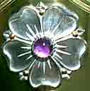 detail view of silver rose set with amethyst